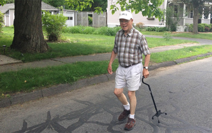 older man walking down street